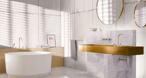 modernes Badezimmer in gold und weiß mit freistehender Badewanne von der Rieger – Ihre Bäderschmiede