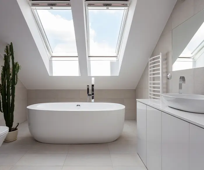 minimalistisches, gut belichtetes Bad mit freistehender Badewanne